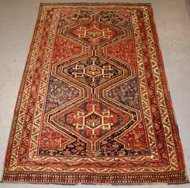 Antique Tribal Qashqai rug, triple linked medallion design with superb colour. 
http://www.knightsantiques.co.uk/596368/antique-south-west-persian-tribal-qashqai-rug-triple-medallion-with-superb-colour-late-19th-century/
Size: 6ft 9in x 4ft 4in (206 x 133cm).
             