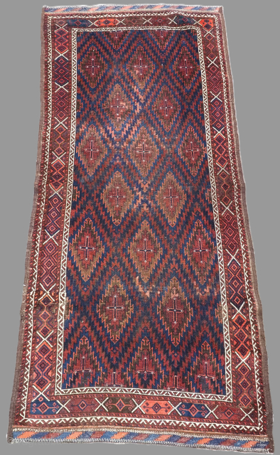 Antique Arab Baluch rug of scarce design from south east Persia. www.knightsantiques.co.uk

Circa 1890.
Size: 6ft 5in x 2ft 11in (196 x 90cm).
This unusual rug has a design of serrated diamond medallions arranged in  ...