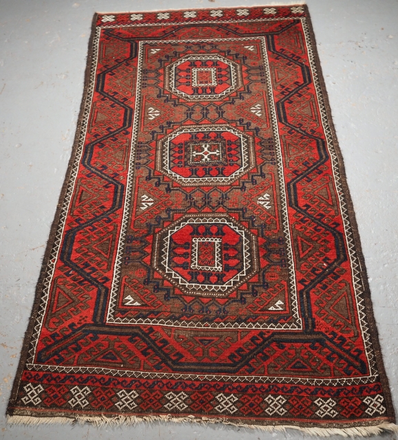 Antique Baluch tribal rug woven by the Salar Khani sub tribe. www.knightsantiques.co.uk

Size: 5ft 9in x 2ft 11in (174 x 89cm). 
Circa 1900.

The rug has three large turreted guls on a soft brown  ...