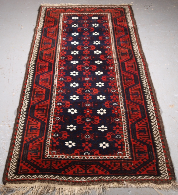 Size: 6ft 8in x 3ft 1in (203 x 95cm). www.knightsantiques.co.uk 

Antique Baluch rug from Western Afghanistan / Eastern Persia. A Baluch rug with a mina khani design on a dark indigo blue  ...