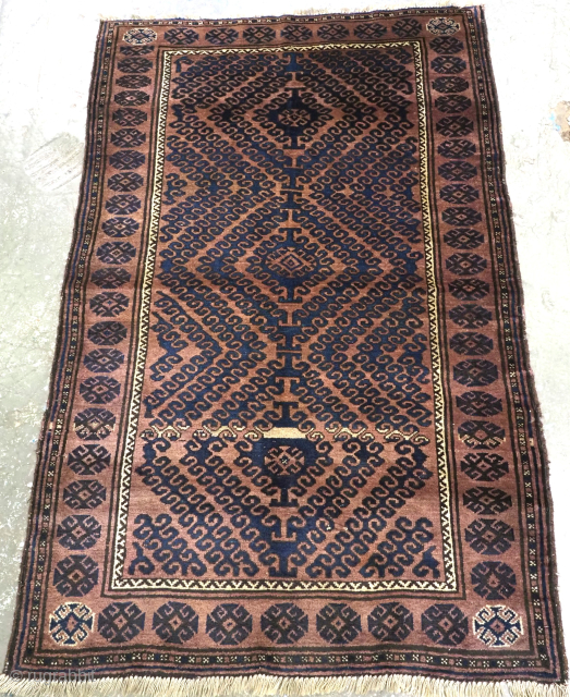 Size: 5ft 11in x 3ft 8in (180 x 113cm).

Antique Afghan Adraskhan Baluch rug of traditional ‘Mushwani’ design, the rug is of a warm colour with indigo blue.

Circa 1900/20.

This group of rugs made  ...