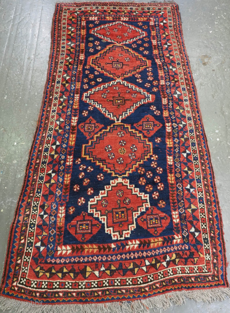 Size: 9ft 6inx 4ft 8in (290 x 142cm).

Antique Luri tribal long rug with medallion design.

Circa 1900.

This rug is an excellent example of Luri tribal weaving, with a field of five latch hook  ...