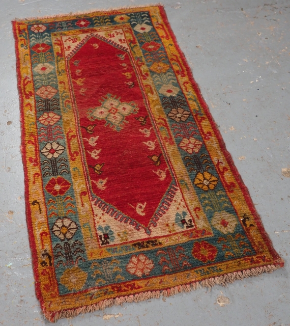 Antique Turkish Kula Oushak rug with a superb range of colours.
www.knightsantiques.co.uk
Circa 1900.
Size: 4ft 6in x 2ft 2in (138 x 66cm).
The rug has a small central medallion on a clear red ground with  ...
