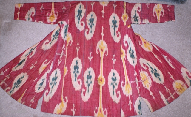 19th century Uzbek Adras Silk wrap/ cotton weft Ikat Chapan ( Coat). Excellent natural colours and bodom gul (almond) design. Beautiful linen, spectacular cross stitches on neck part edges. Reasonable price.   ...