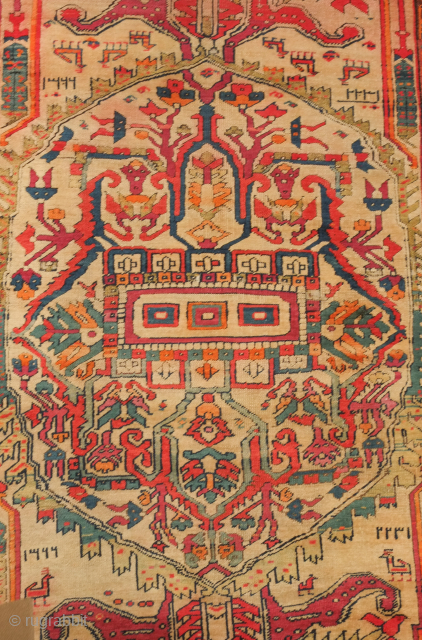 NW Persian rug, dated 1907. Central medallion and large pendant arrangement in a wild drawing. Goats in the field and human-like figures in the central medallion. Unusual. 105 x 227 cm  