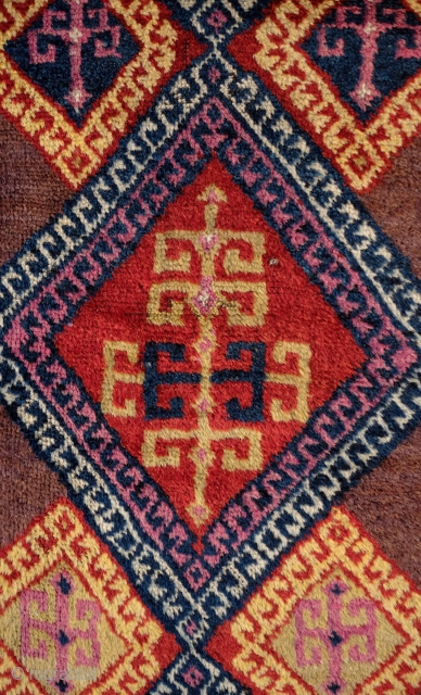 Adiyaman Kurish Long Rug, 4th quarter of the 19th century. Rich purple ground with hooked medallions with directional hooked motifs resembling an archaic tree of life in the center of each.   ...