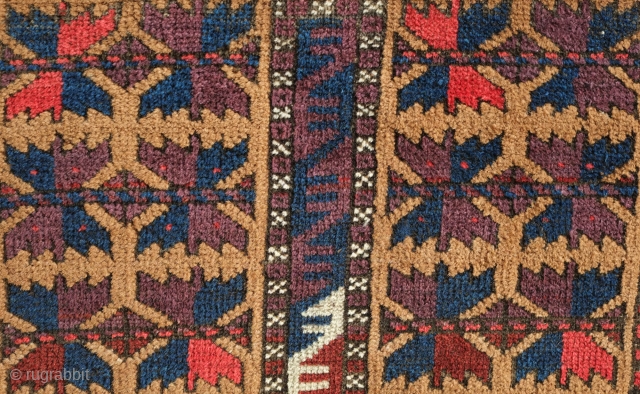 Khorasan Baluch rug, late 19th century.  Tree of life design over a camel wool ground.  Vivid purple in the leaves.  Some damage on one side of the selvedge.   ...