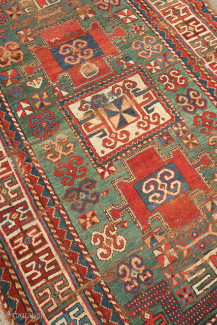 Fachralo green ground rug, 19th century. Wonderful field of green, kochanak border and elibelinde motifs on both ends of the field.  Obvious wear but all there. 132 x 234 cm  