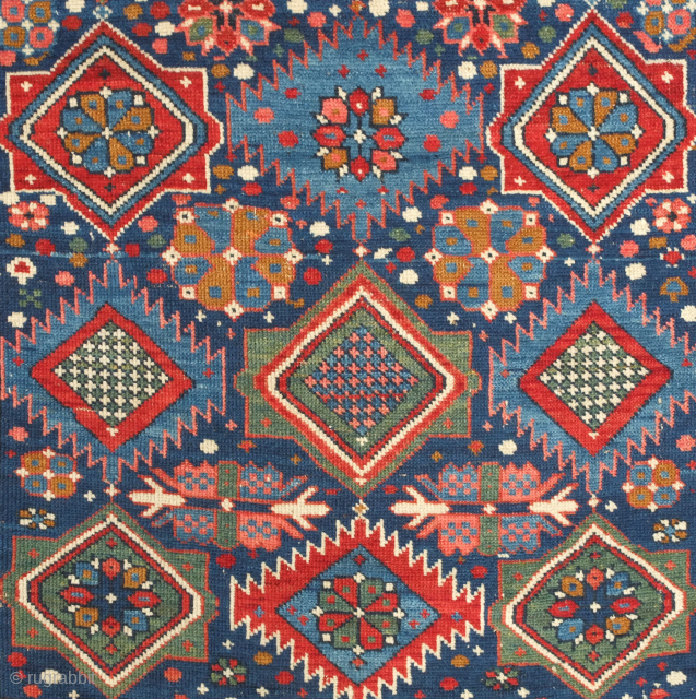 Kuba rug, 19th century. Stunning saturated jewel-like colors. This Kuba rug is brimming with a variety of palmettes and medallions. Striking kufic border. Excellent condition. 128 x 213 cm.    