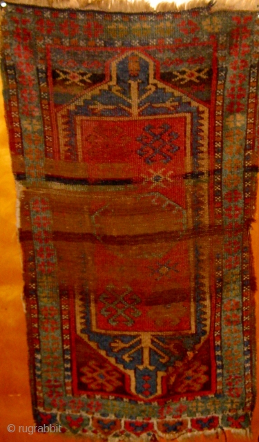 Antique central Anatolian yastik, 19th Century,  distressed but still noble, all natural dyes, 22" by 39".  Please ask for additional photos.          