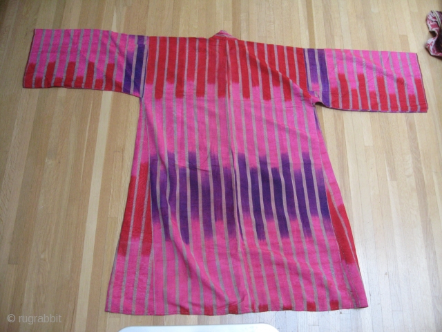 All silk Adras striped Uzbek ikat Kurta. Early 2oth century. Sleeves 66xlength 45in (168x114cm).Excellent silk embroidered frontal trim .Unusual 3 color (Pink, red and Purple). ikat Condition wearable with no tears, holes,  ...