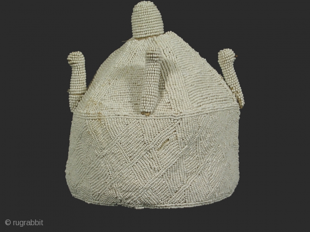 Chief's crown, Yoruba tribe, Nigeria, glass beads and cotton, mid 20th century,diameter 8 inches, height 9 inches. The projections from the upper, conical part of the hat represent birds.    