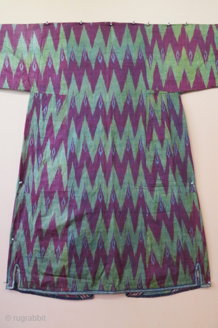 Uzbek coat, silk warp ikat, cotton weft, 19th c.,60 inches across the sleeves, 52 inches high, in excellent condition with light overall soiling ( could stand to be drycleaned).    