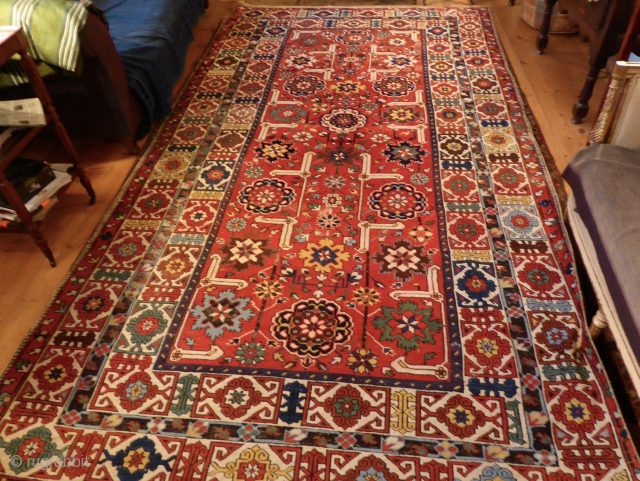 Coming soon ... Rather beautiful, with a bright festive red ground, this Shriven/Kuba small carpet is unusual for it's size; it has an attractive field of stylised floral medallions, enclosed within a  ...