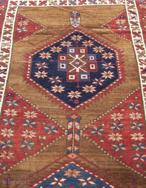 A simple and plain runner (  it s Kurdish or Azerbaijan )  with four medallions or six-sided diamionds and some abstract floral motives on a spacious  camel ( wool  ...