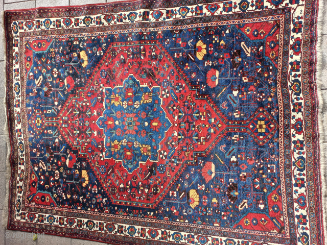 Can someone please identify the type of carpet for me? Is it an antique Shiraz? Because I don't see any Shiraz motifs.           