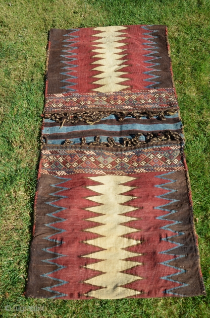 Caucasian Kazakh flat woven khorjin. 4 ft. 8 in. X 2 ft. 19th C. Wool. Natural colors. Excellent condition. Slitwoven with brocaded elements in bridge.        