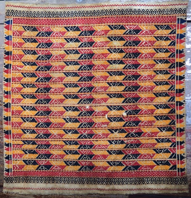 Indonesia | Antique ceremonial weaving tampan
 
Indonesia, Sumatra, Lampung, c. 1900
 
Handspun cotton base, supplementary weft weaving, botanical dyes, gold-wrapped thread 
 
A large, festive tampan with a colourful geometric design of  ...