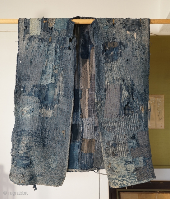 Indigo Tsugihagi (Patch-Worked) "Boro" from 19th century Japan. 
This boro seems to have been a work wear, and been stored and waiting for being reformed again.
Now this doesn't have sleeves and the  ...