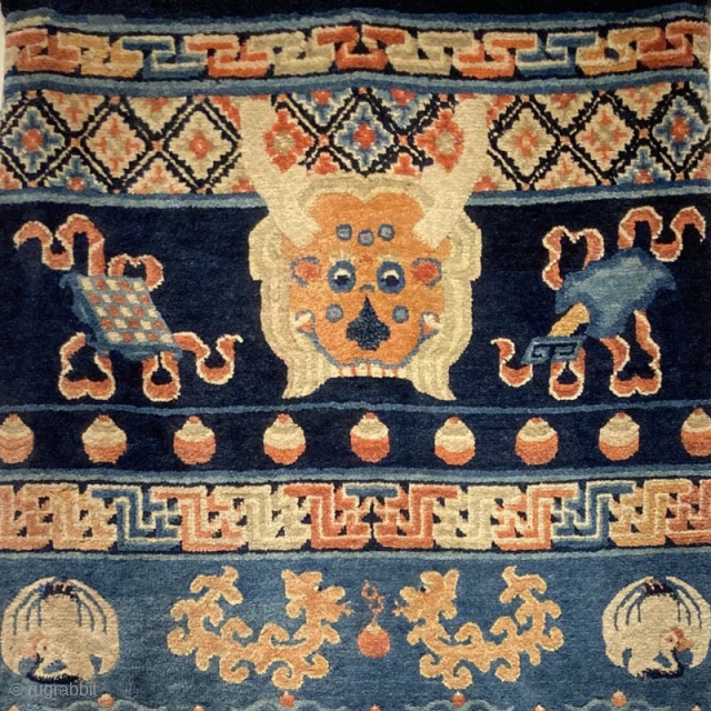 19th century pillar rug 2.07m by 0.97m
Full pile rug, the white wool has corroded noticeably to the surrounding pile. 
Note the Mongolian (?) script, and mixture of religious motifs, e.g.cranes, dragons, buddhist  ...