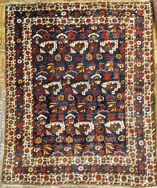 Small Afshar Carpet, 5’3” x 6’6” / 169 x 198 cm.
Floral pattern in field, on indigo ground; white ground 
secondary borders, indigo ground central border 
Good pile.      