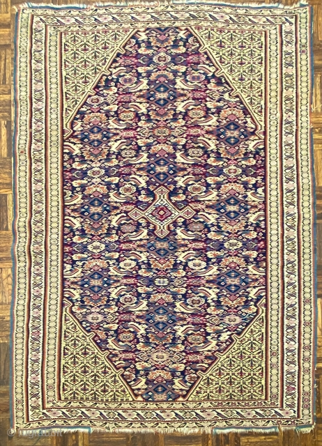 Antique Senn-eh Kilim Rug, 4’1” x 5’9” // 124 x 175 cm

Indigo ground octagonal field with crisply drawn variant of the Herati design with a small

diamond shaped medallion with four small pendants  ...