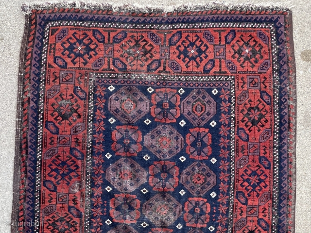 Antique Baluch rug with unusually good purple. 2'9" x 4'11". Selvedge missing on one side but backed by fabric.              