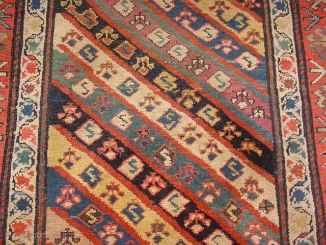 wonderful antique 1880 gendjeh rug, wonderful natural colors, great fuchsia color also, 
some minor low pile, two small repairs, complete headends, two deliberate incisions, to make it lay perfectly flat, no stains

110x263cm
3.7x8.8ft 