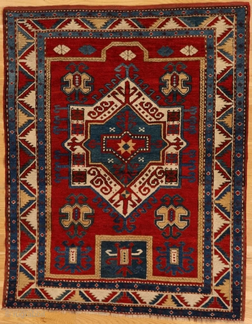 Fachralo prayer Kazak rug from southwest Caucasus

Age: circa 1870

Size: 4′.9″x3′.9″ (145×114 cm)

The saturated madder red field displays a characteristic niche subfield with a square lower re-entrant and an upper faceted section.In the  ...