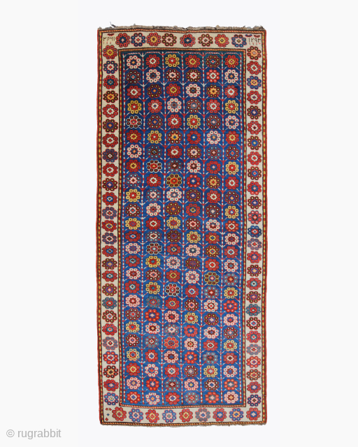 The date on this extraordinary long carpet is not clearly legible. Its independent design and the good colours,unusual blue ground with this design however, suggest an early origin. Even pile with original  ...