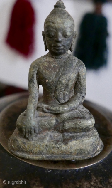 Antique bronze miniature Burmese Buddha sitting in Bhumisparsha mudra posture.  Extremely old - 16th c?  older?.  Most likely excavated from beneath a stupa in old Burma.  3 1/2"H

SOLD 