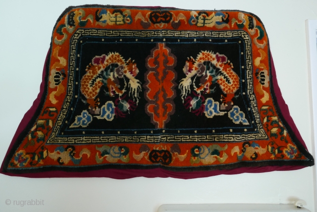 Tibetan saddle blanket,  first quarter 20th cent., good wool,  and full pile.  The fabric protecting the  back is not original.         