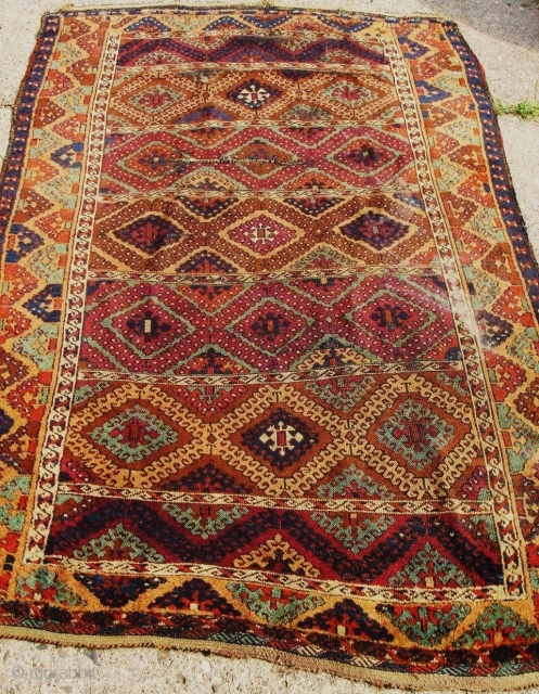 Anatolian Kurdish Yoruk rug. 50X79 Inches... 127X201 Cm. All intact with braided ends. Mostly good pile, some wear, dirty with washable stain and a crease cut as shown.     