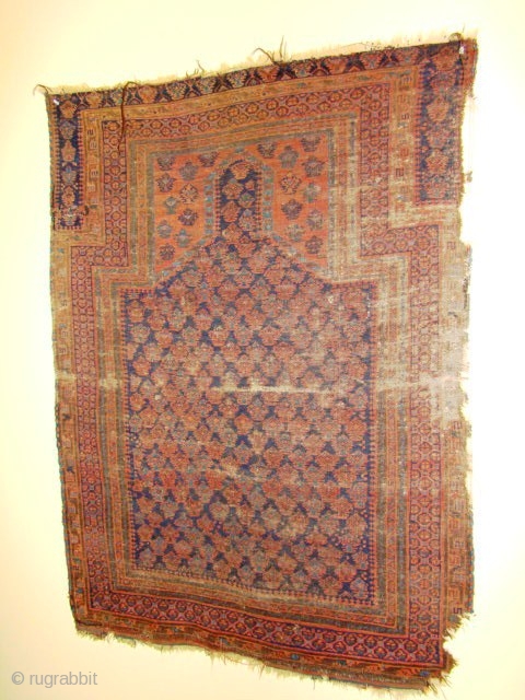 Battered but old Baluch Prayer Rug. Has remnant of the bottom end kilim and the left side has the original selvedge. Size: 38X50 inches 97X127 Cm       