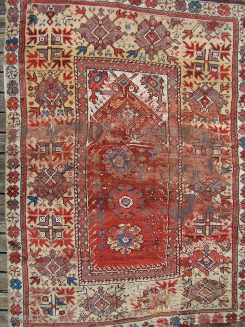 Turkish Milas Prayer Rug. Size: 46X65 inches 117X165 Cm.
Has two hand size patches and the worn areas have backing glued to them so the foundation warps are still there.    