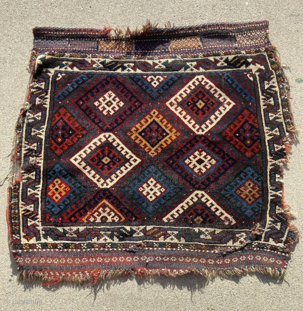 Fine Jaff bag face with an unusual color palette featuring two purples. Nice saturated dyes. Obvious condition issues but still a really great piece with a good range of colors. The wonky  ...