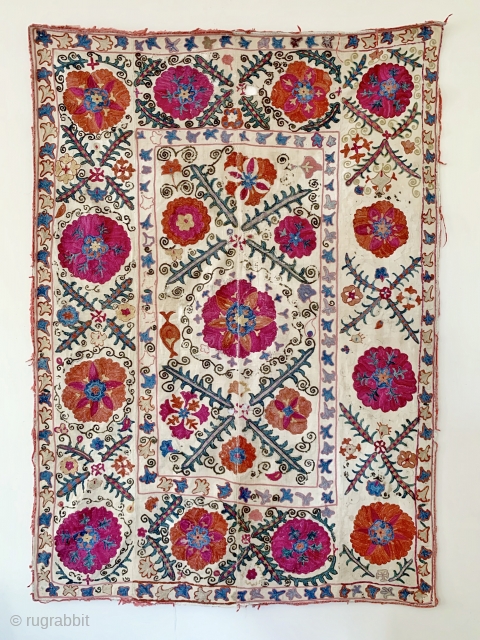 A beautiful antique Uzbek silk suzani from 3rd quarter of the 19th century rural Bukhara. It has fine polychrome silk chain-stitched embroidery on a cotton ground known as Karbos. The classic floral  ...