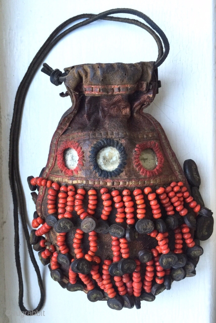 A very rare antique Beaded leather bag from Tibet or Ladakh India. Dating to the 19th century, such bags were part of the Buddhist traditions of the Hamaliyan people. The blood red  ...