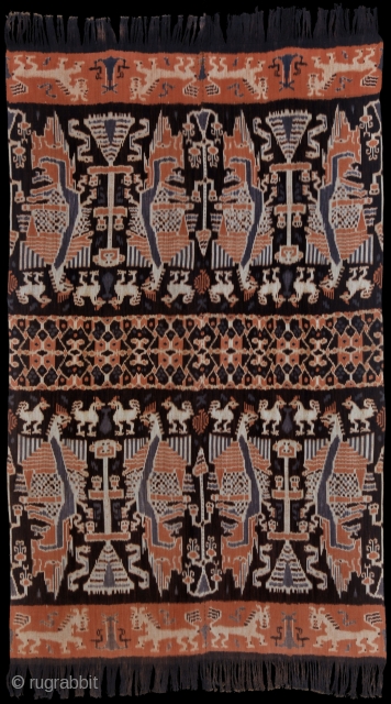 Man's mantle, hinggi. East-Sumba, Indonesia, 1950s.

Large fighting cocks (or dragons?), horses, fish, lions, cockatoos, snakes, and skull trees in white, morinda red, two shades of purplish black. Centre field with patola ratu  ...