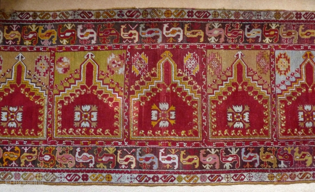 A charming central Anatolian prayer saph, c.1900, with a typically vivid palette. 320 x 103 cm. It is in very good condition, with a little loss at one end, a small bite  ...