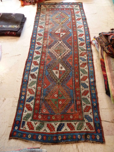 An early Shulaver or South Caucasian rug 260 x 99 cm, with wonderful bright, clear colours. Mixed wool and cotton wefts. Quite a lot of wear as you can see, but still  ...