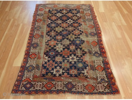 http://jessiesrugs.com/caucasian-rugs/518-caucasian-oriental-rug-4-1-x-6-1-blue-kuba.html

This antique Caucasian Kuba rug is in fair condition. The design features an all-over snowflake pattern set in a blue field with ivory, red and brown highlights. There is moderate wear on  ...