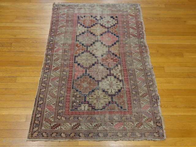 http://jessiesrugs.com/caucasian-rugs/304-antique-caucasian-oriental-rug-3-7-x-5-2-blue.html

This antique Caucasian rug is in fair condition. The field is filled with geometric medallions with pink, purple, and cream highlight colors. There is wear on the edges and fringe ends. Most  ...