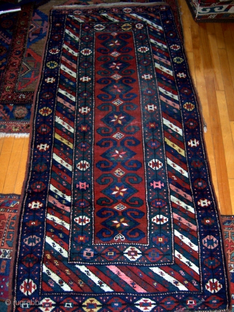 Southern Caucasian (Gendje/Kazak) rug.  34" x 74".  Borders have thick pile, parts of main field has low even pile.  Areas of repiling that were poorly done with regard to  ...