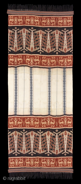TE02180

2014 Hinggi Pahikung Pataduku, man's ceremonial shawl, cotton with indigo, orange and dark purple brown ikat patterns of two rows of hammer head sharks divided by plain white center with narrow bands  ...
