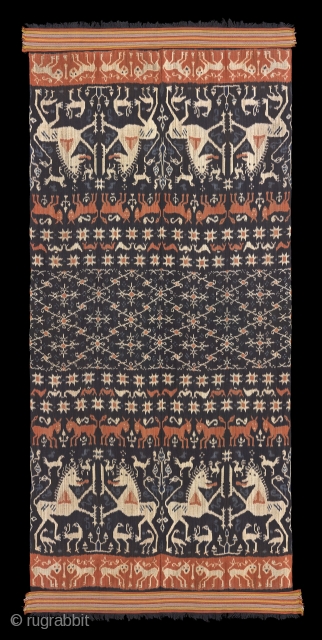 TE02379

1940s Hinggi Kombu, man's ceremonial shoulder wrap, cotton dark brown with warp Ikat patterns of rows of large white mahang (Lions) and orange horses with a large patola ratu band in center.  ...