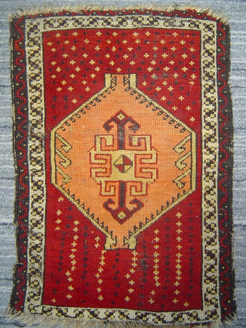 Anatolian yastik with amber hexagon spaceship medallion soaring over star-studded crimson field.  51 x 74 cm. -- Late 19th century.            