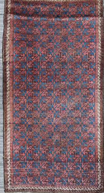 Antique Baluch symmetrically knotted wool rug with Interlocking Geometric Motifs in Grid Repeat forming a complex reciprocal pattern, 33 x 64 inches / 84 x 163 cm. Deep saturated colors on glowing  ...