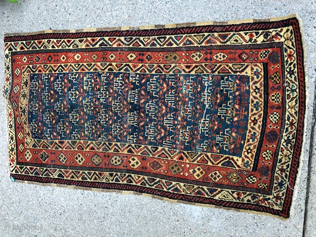 This antique rug is a stunning piece from the Caucasian region of Azerbaijan, dating back to the 1920s. Measuring 64 inches by 32 inches, it features a beautiful multicolor design that is  ...