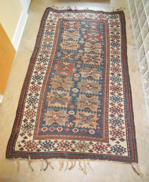 Antique Kazak Caucasian rug in good low pile condition. Still has some of its original tassel endings. 4'6" x 7'6."             